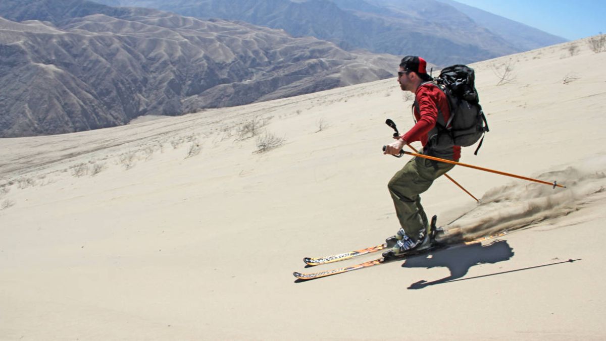 Man skiing on sand.