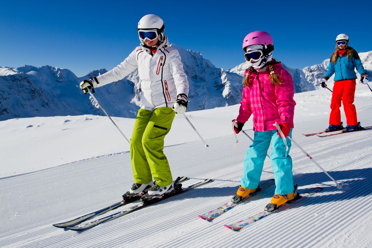 A group of skiers skiing together on slope downhill. 