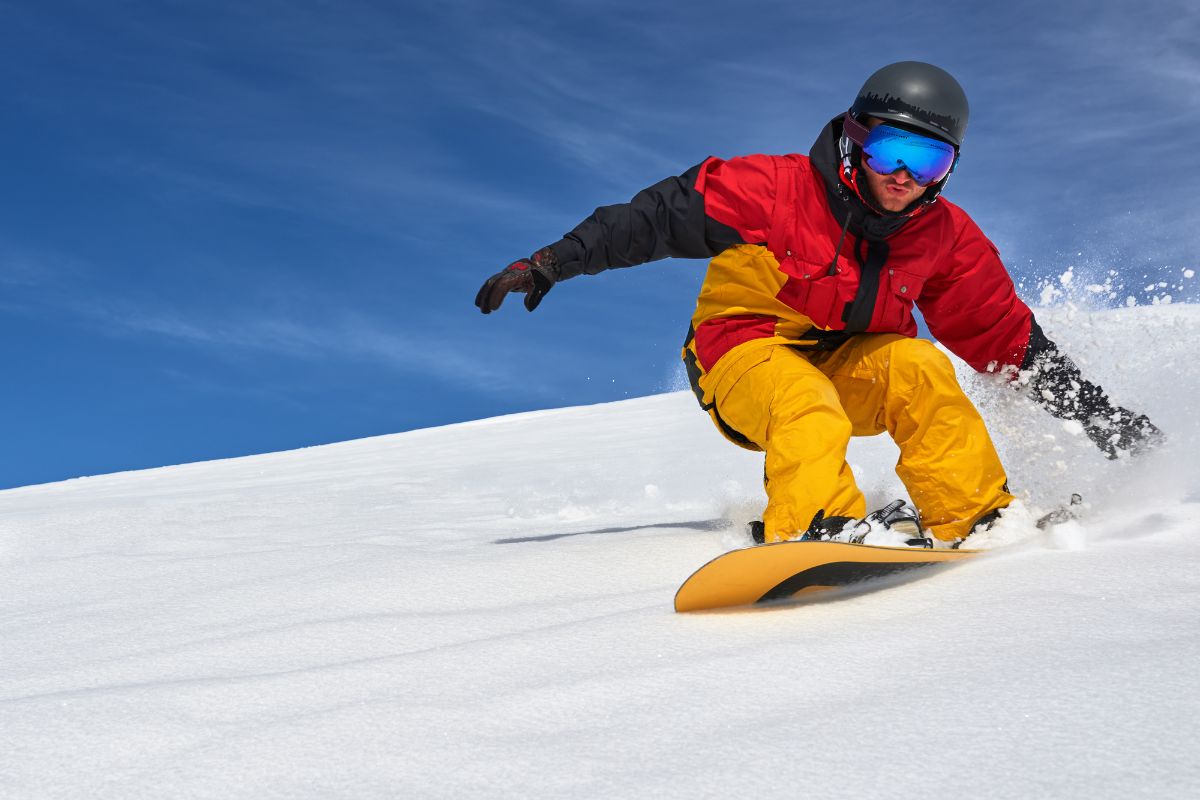 Man skier skiing on the dry snow slope.